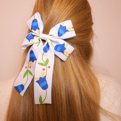 Baltas kaspinukas su mėlynomis gėlėmis